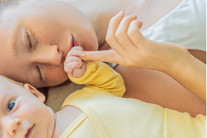 Mother and baby lying on a play mat, a Person Photo by Elizaveta Galitskaya