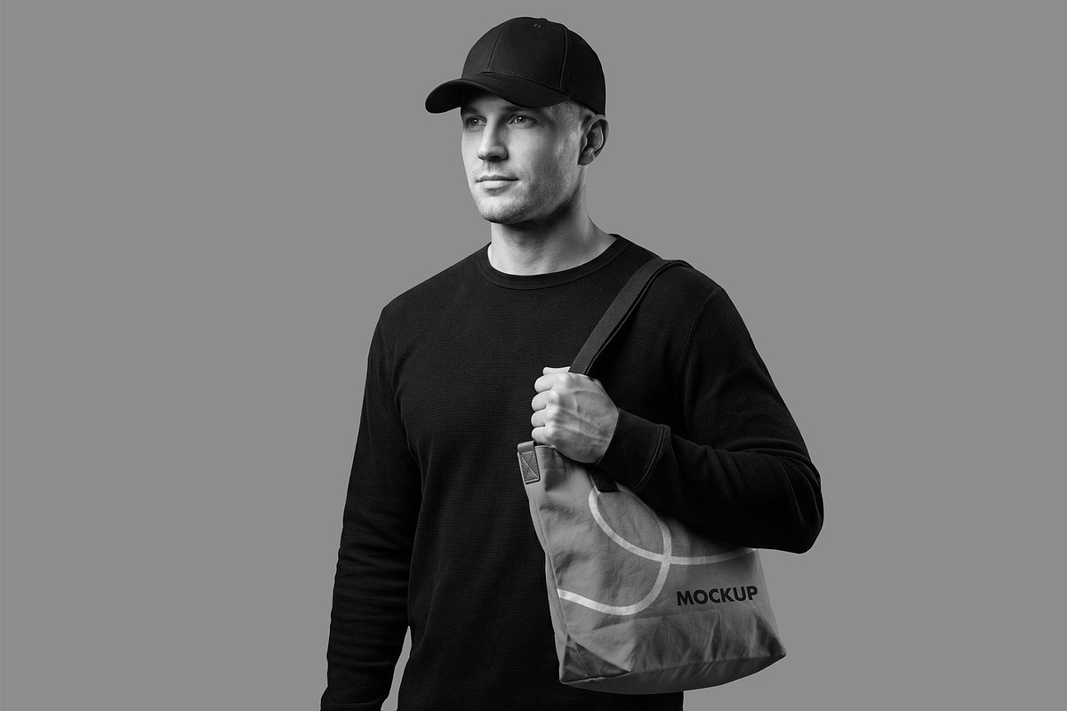 Canvas Tote Bag Mockup with Man, a Merchandise Mockup by graphypix (Photo 4 of 4)