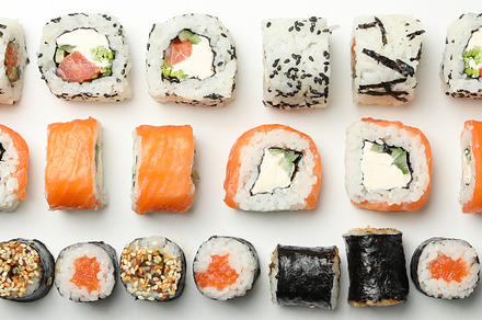 Flat lay with sushi rolls on white background. Japanese food, a Food & Drink Photo by AtlasStudio