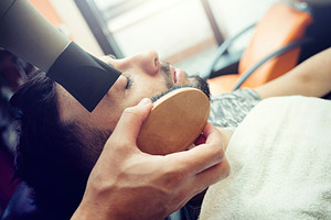 Professional barber styling client's beard with hairdryer and brush, working at, a Person Photo by Antonio Gravante Market
