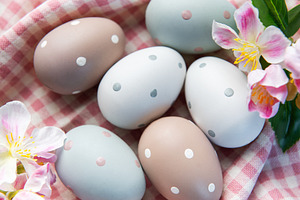 Pastel easter eggs with polka dots on gingham fabric, a Holiday Photo by Olena Rudo