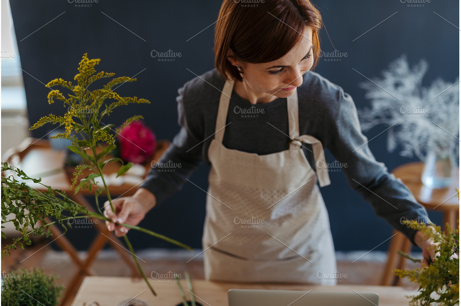Female florist working in her small, a Person Photo by HalfPoint