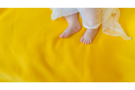 Baby feet on a yellow background, a Person Photo by yanadjana