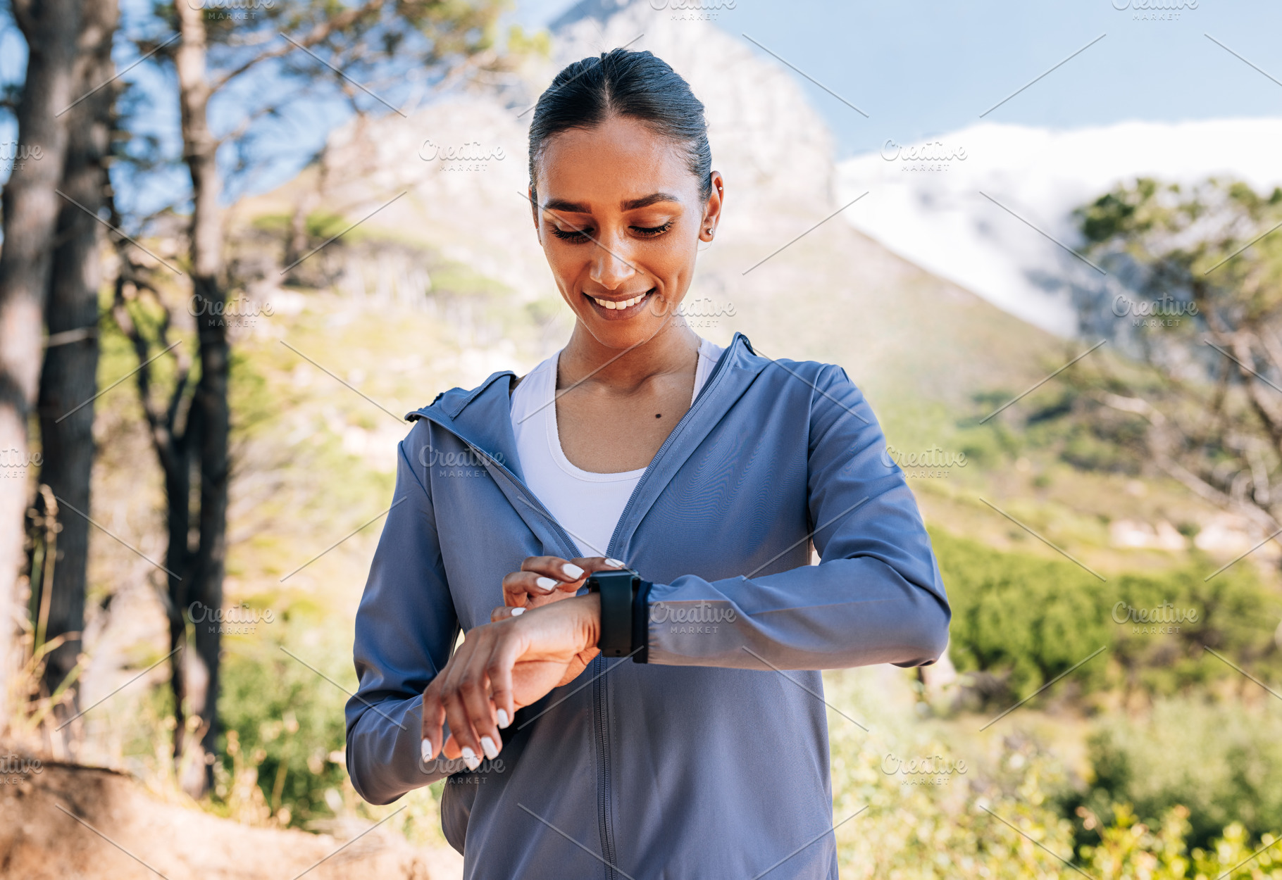 Cheerful woman checking pulse, a Sports & Recreation Photo by Artem Varnitsin