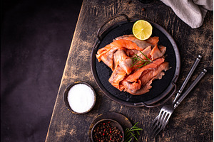 Salted sliced salmon fish with herbs, a Food & Drink Photo by Yulia Furman