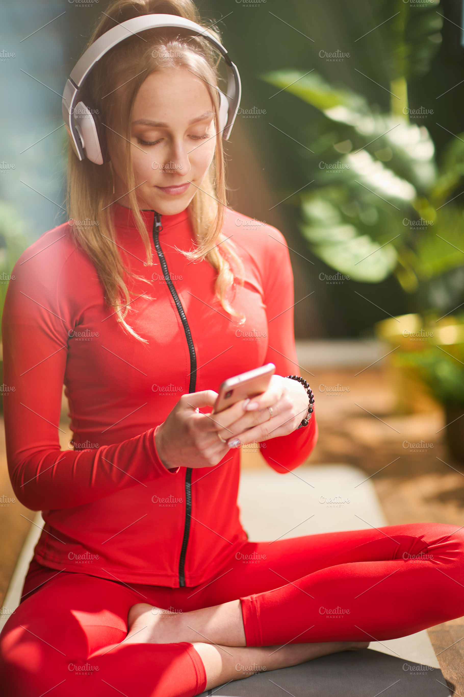female in green living room listening to music, a Person Photo by Alliance Images