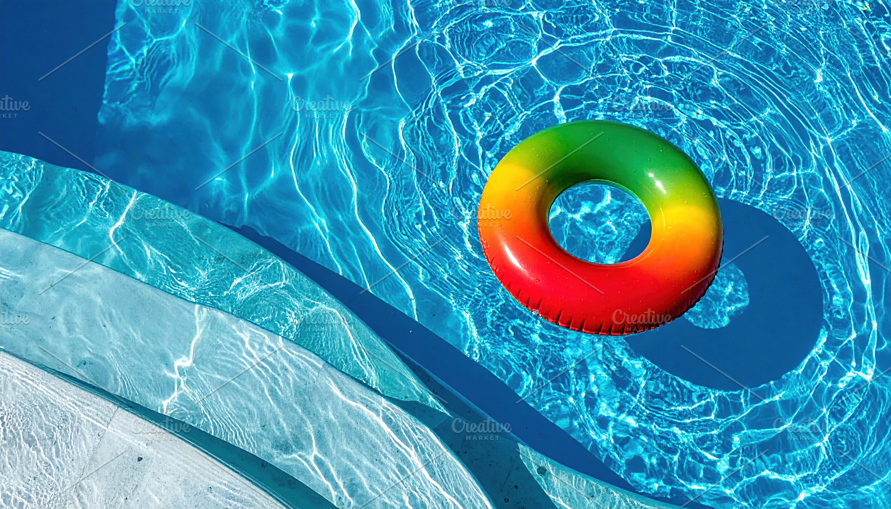 Colorful Inflatable Ring Floating in Clear Blue Pool, a Sports & Recreation Photo by Davizro's Market