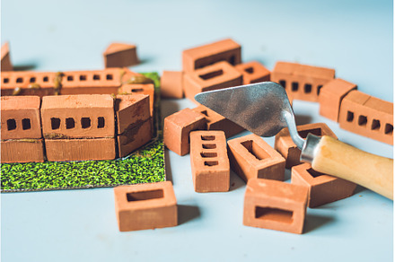 Real small clay bricks at the table, an Architecture Photo by Elizaveta Galitskaya