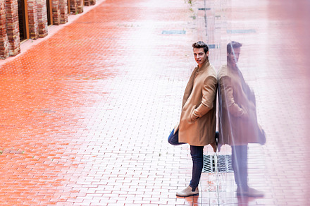 Portrait of stylish handsome young man with coat standing outdoo, a Person Photo by RF Images
