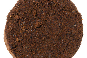 Pressed tablet of used ground coffee, coffee puck or cake, top v, a Food & Drink Photo by ndanko