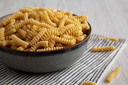 Raw Dry Organic Italian Fusilli Corti Bucati in a Bowl, side vie, a Food & Drink Photo by LiudmylaChuhunova