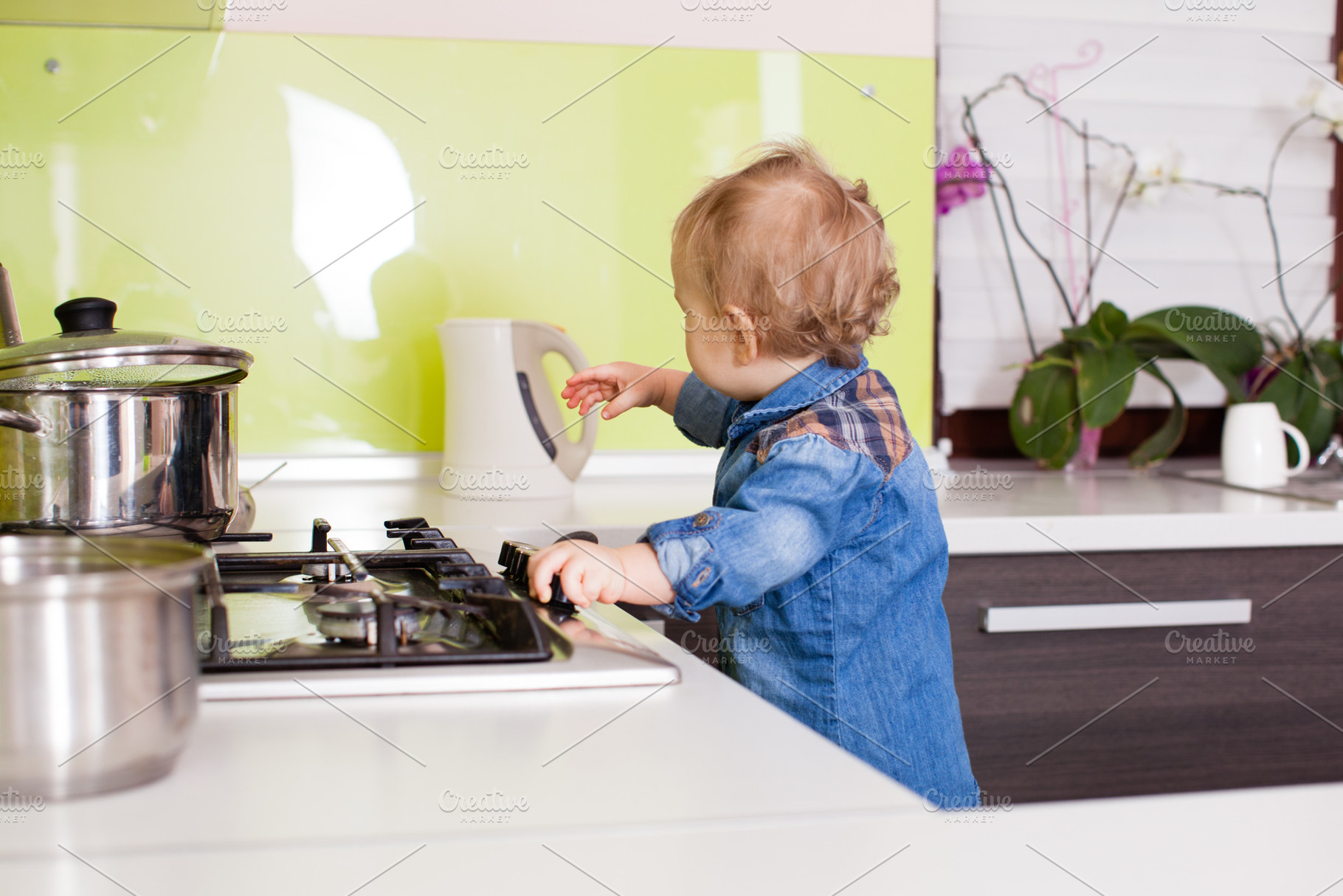 Baby boy near the gas stove, a Person Photo by oksix