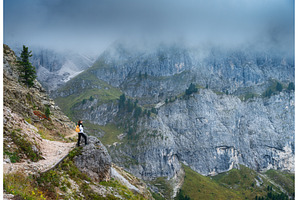 Woman with backpack standing on, a Person Photo by den-belitsky