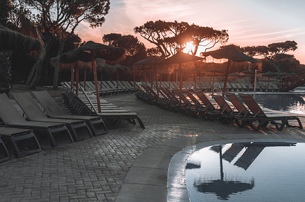 Sunset poolside with empty loungers, a Sports & Recreation Photo by SkyNext