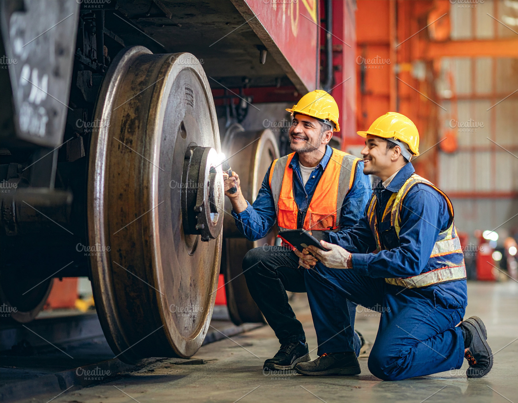 Train mechanics checking a train wheel, an Industrial Photo by DanFLCreativo