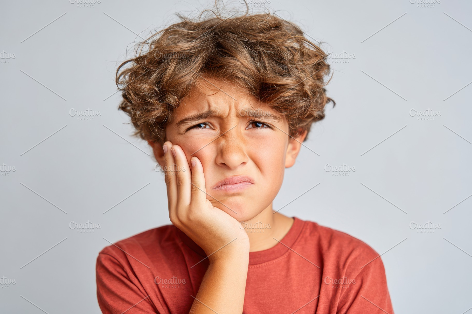 Young child making a disgusted face because of a toothache, a Health & Medical Photo by AlyaAnd