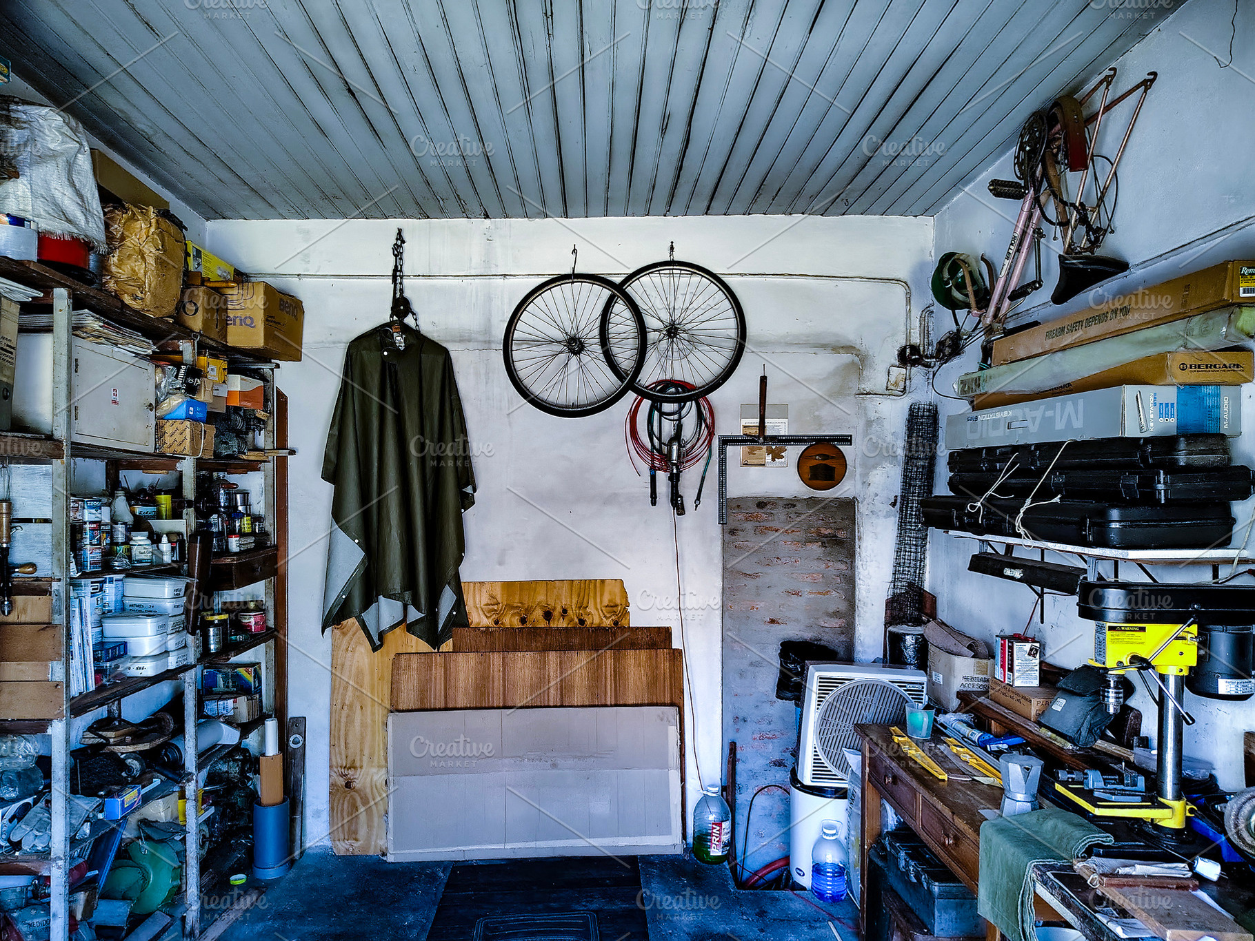 Garage with various tools, wooden materials, and mechanical comp, an Industrial Photo by DanFLCreativo