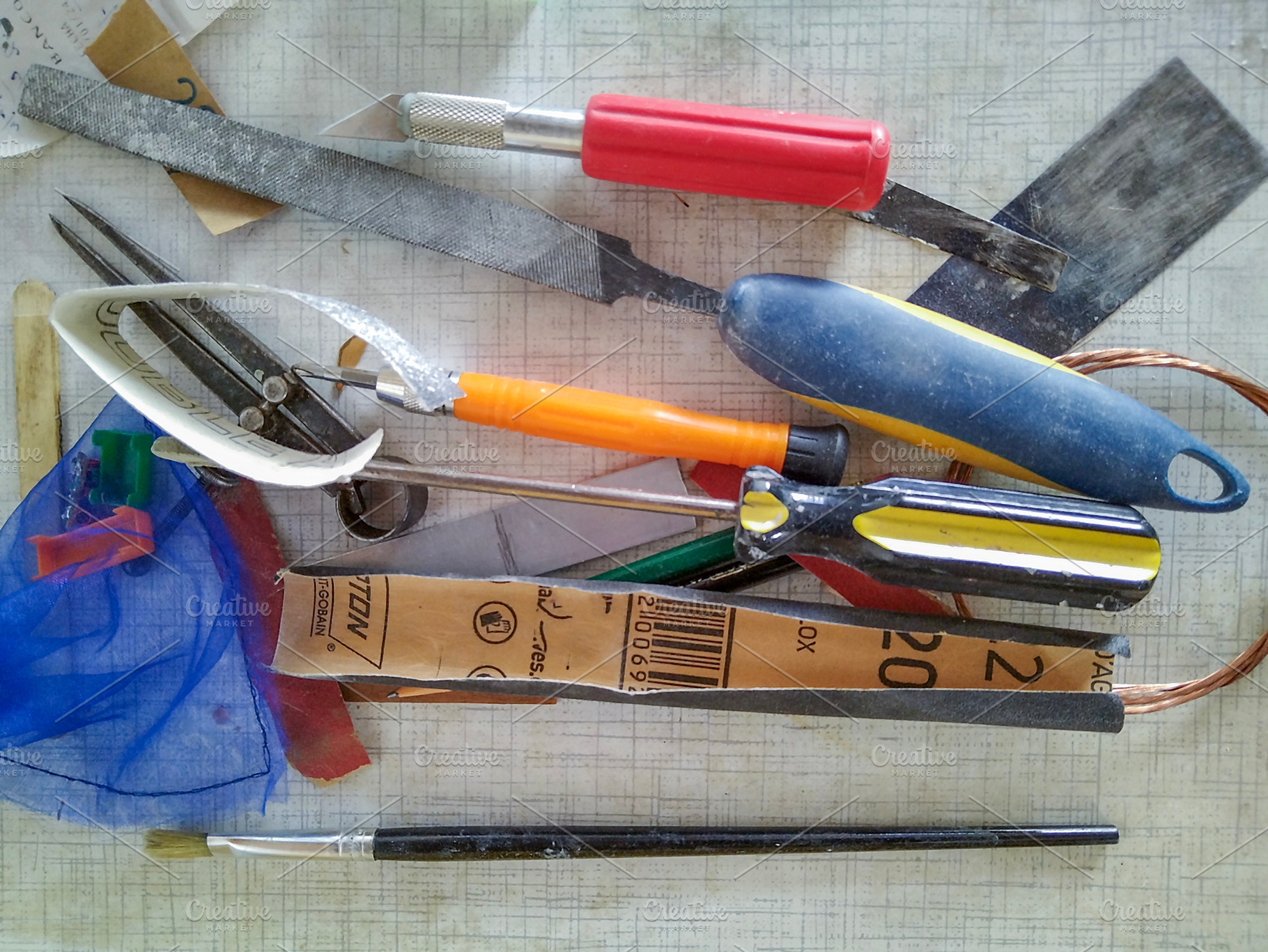 Scattered hand tools on white grid workspace, a Nature Photo by DanFLCreativo
