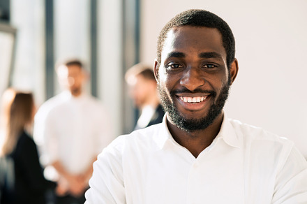 Smiling black man in office, a Photo by borodai94