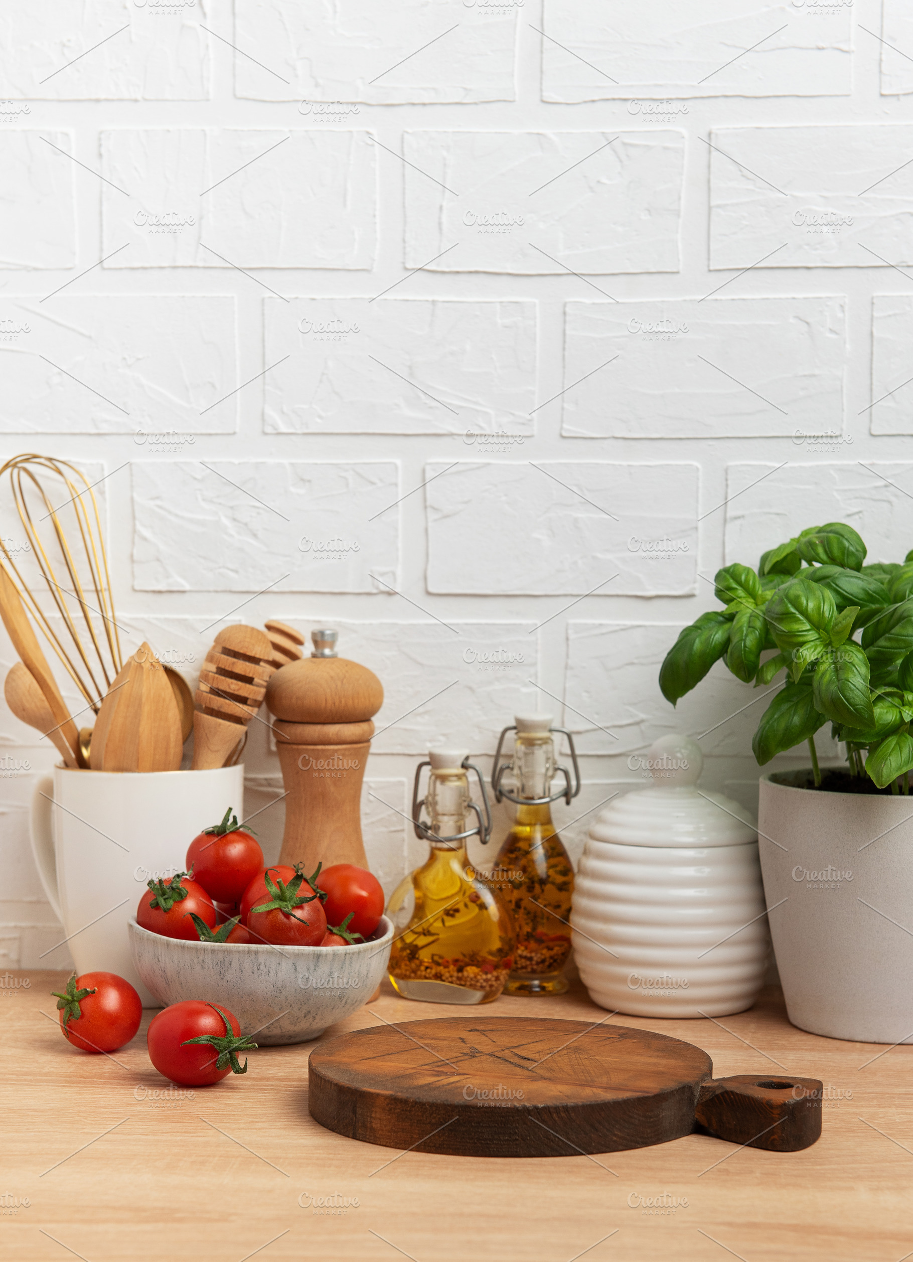 Kitchen countertop with cutting board, tomatoes, spices, and bas, a Food & Drink Photo by Olena Rudo