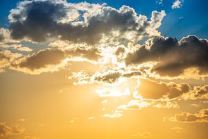 Sunset sky with clouds and sun