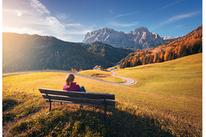 Young woman sitting on the bench and, a Nature Photo by den-belitsky