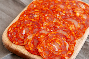 Cold Meat Chorizo Slices on a Wooden Board, side view., a Food & Drink Photo by LiudmylaChuhunova