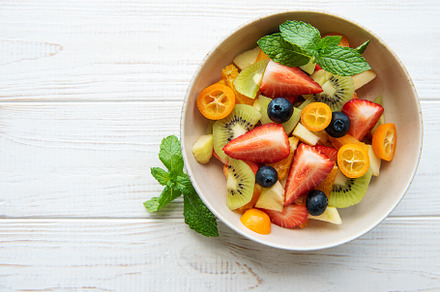Healthy fresh fruit salad in a bowl, a Food & Drink Photo by Olena Rudo