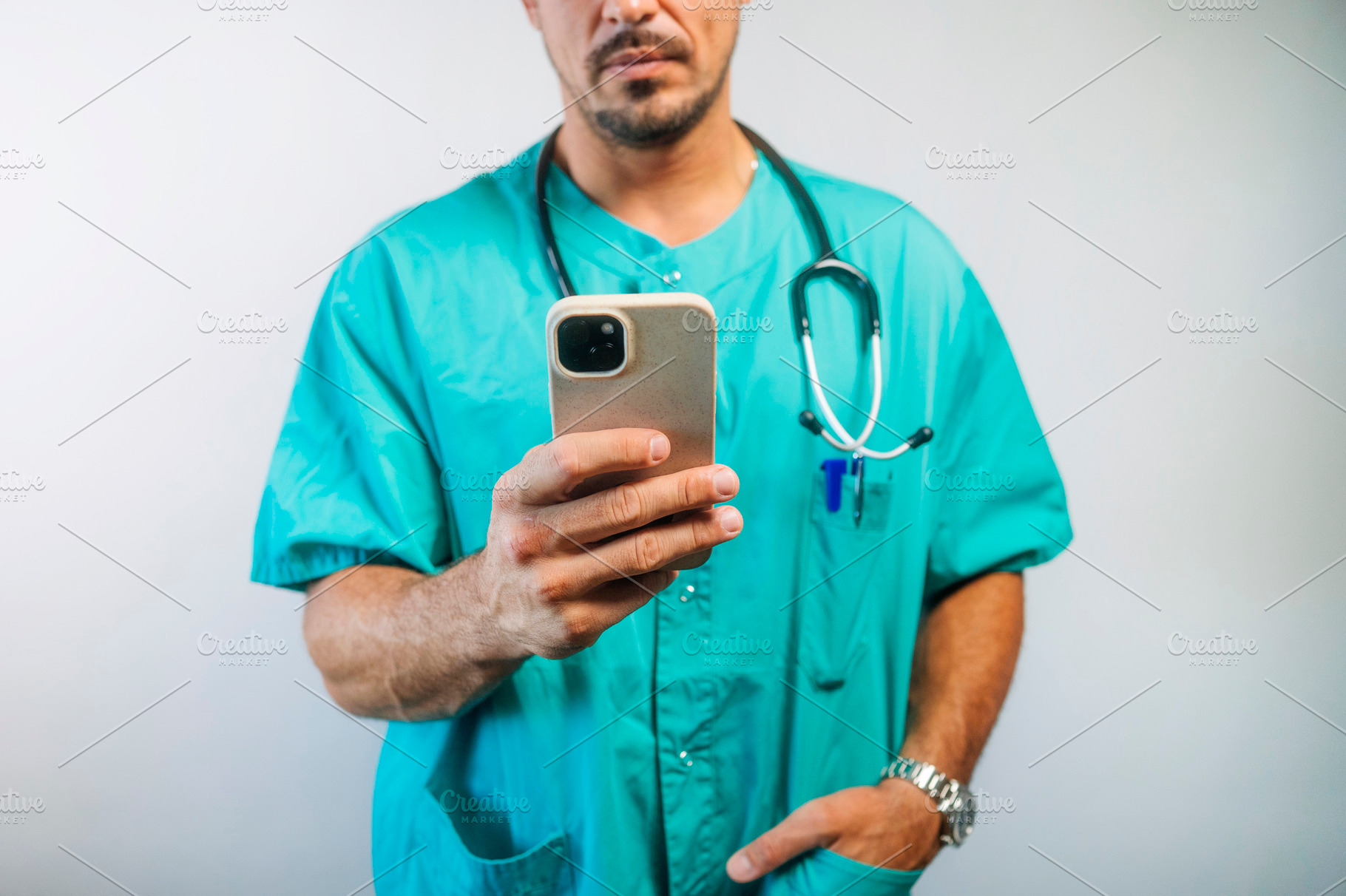 Doctor Using Smartphone in Scrubs, a Person Photo by karrastock