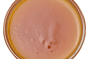 Apricot jam in a glass bowl on isolated background, top view, a Food & Drink Photo by ndanko