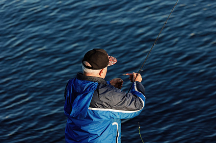 Senior fisherman preparing a hook by