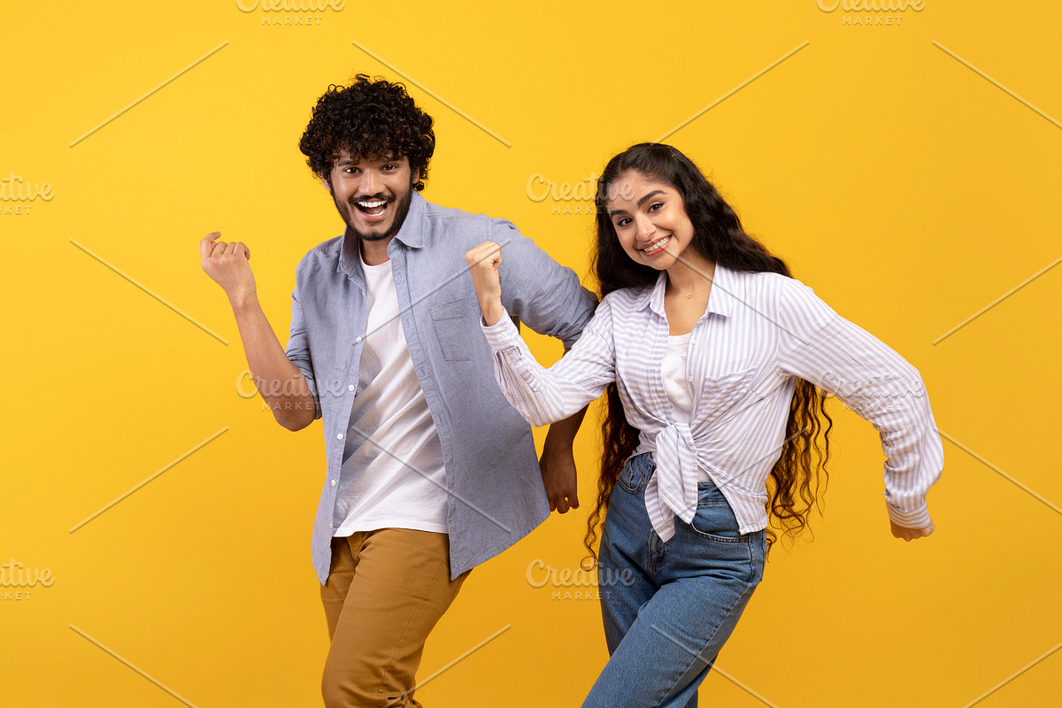 Having fun. Portarit of overjoyed indian couple dancing and fooling around, enj, a Photo by Prostock-Studio (Photo 2 of 2)