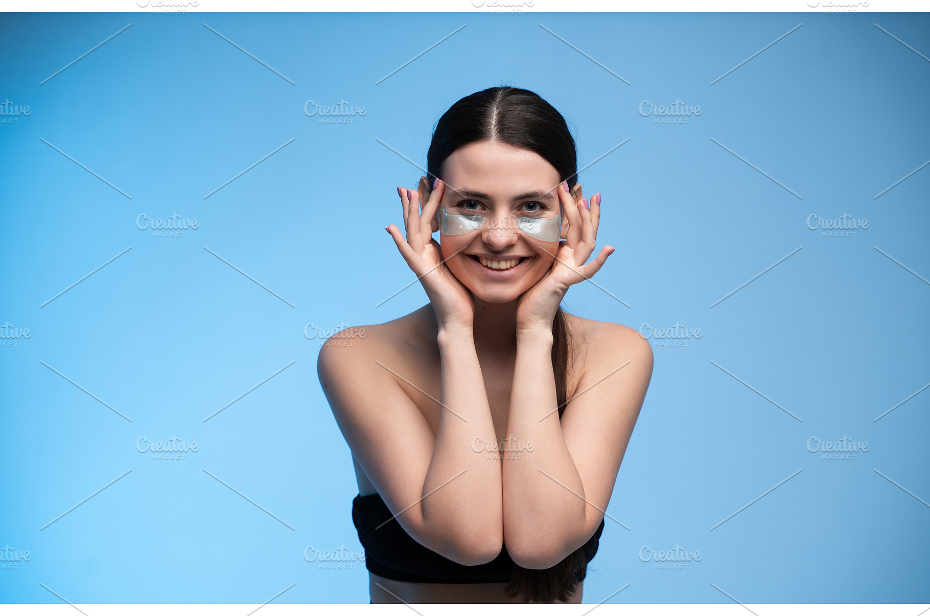 Woman with eye patches smiling for, a Health & Medical Photo by volodymyrshtun13795