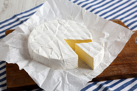 Homemade White Brie Cheese on a Wooden Board, side view., a Food & Drink Photo by LiudmylaChuhunova