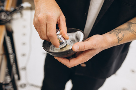 Close-up male hands of barber, clipper with professional tools at barbershop. B, a Person Photo by Volodymyr Melnyk