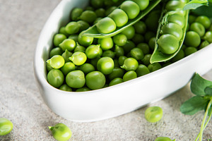 Fresh green peas in bowl representing healthy eating, a Food & Drink Photo by Olena Rudo