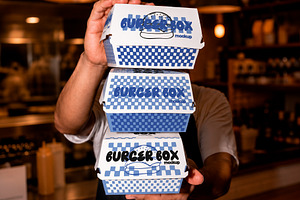 Man Holding Stack Food Boxes Mockup