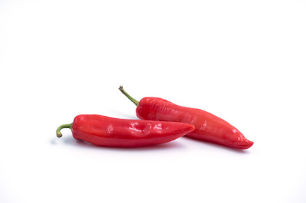 Red chili peppers on white, a Background Photo by wr7 Media