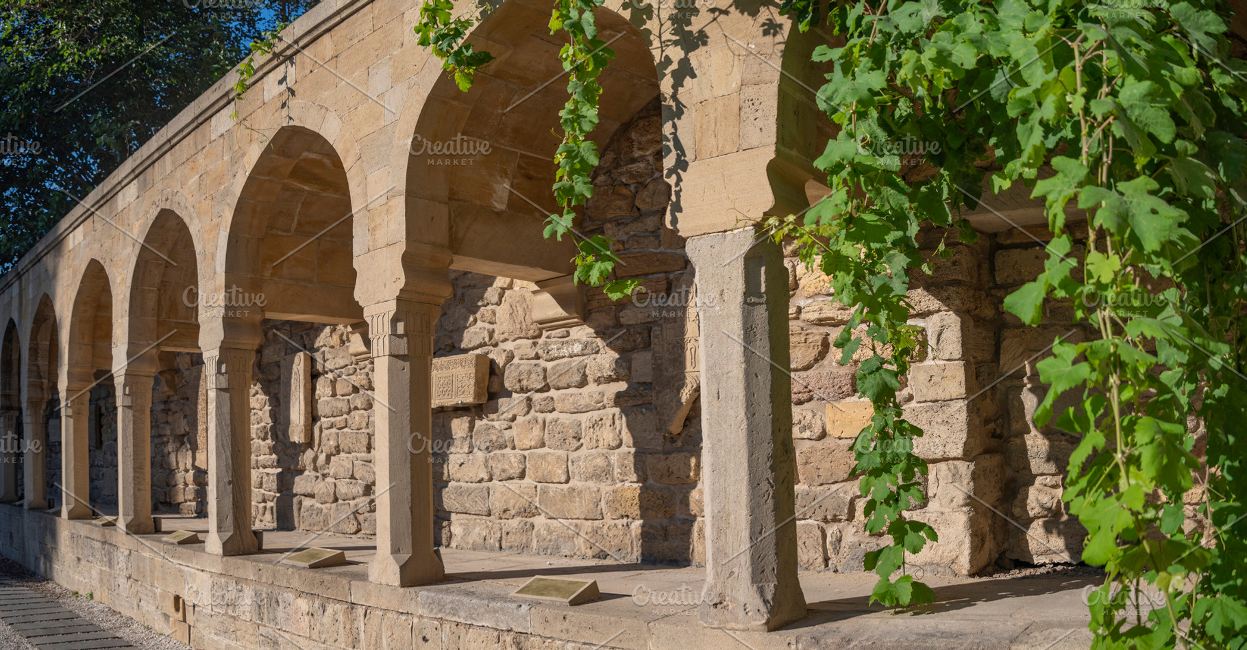 Ancient stone arcade in Icherisheher with green leaves and copy, a Photo by Pictures for you!!!!!!!!!