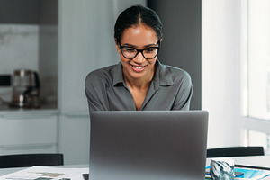 Smiling female in eyeglasses working, a Person Photo by Artem Varnitsin