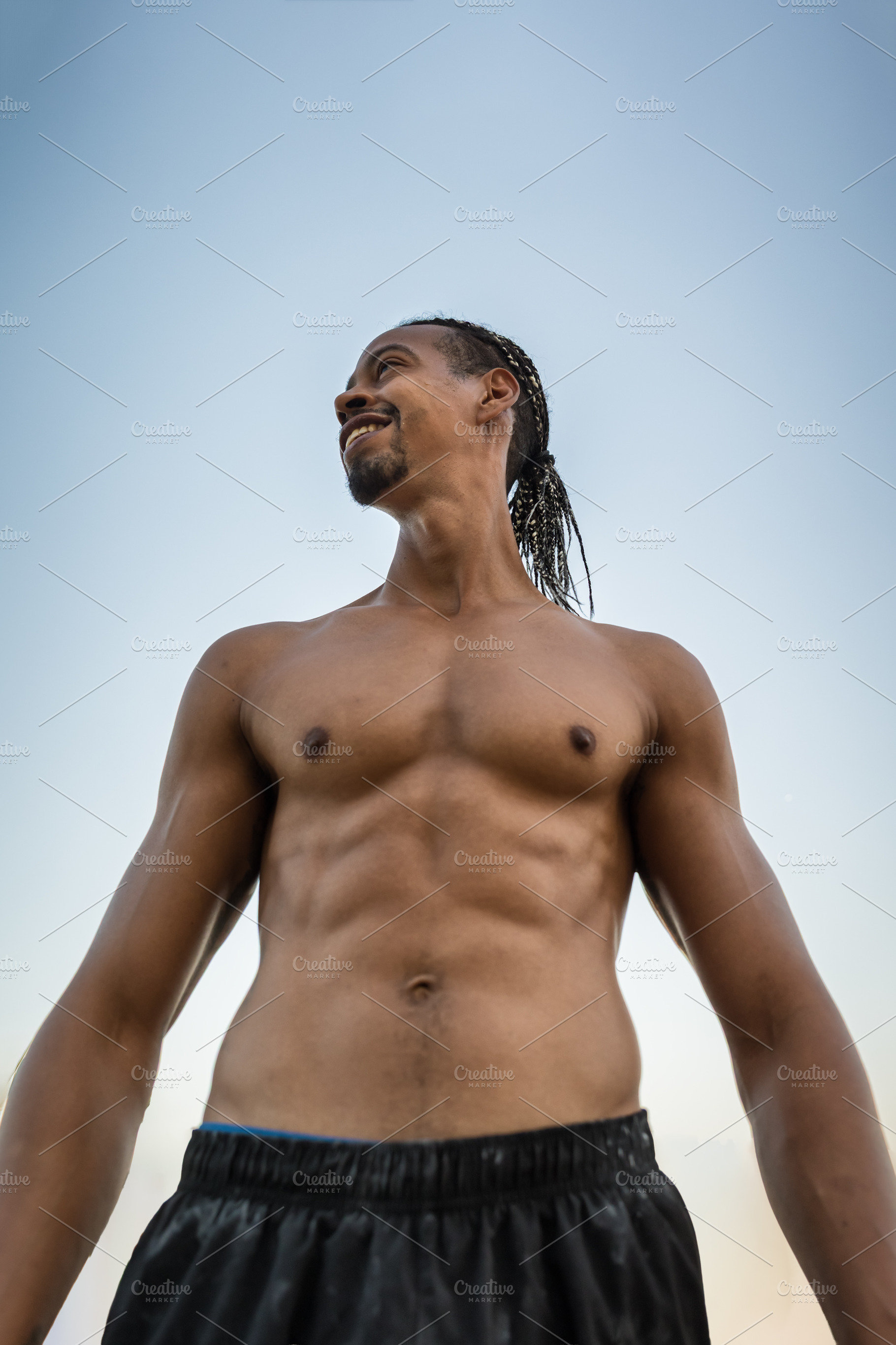 Smiling athletic man outdoors agains, a Sports & Recreation Photo by Perpis