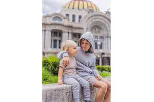Two young boy tourists in front of, an Architecture Photo by Elizaveta Galitskaya