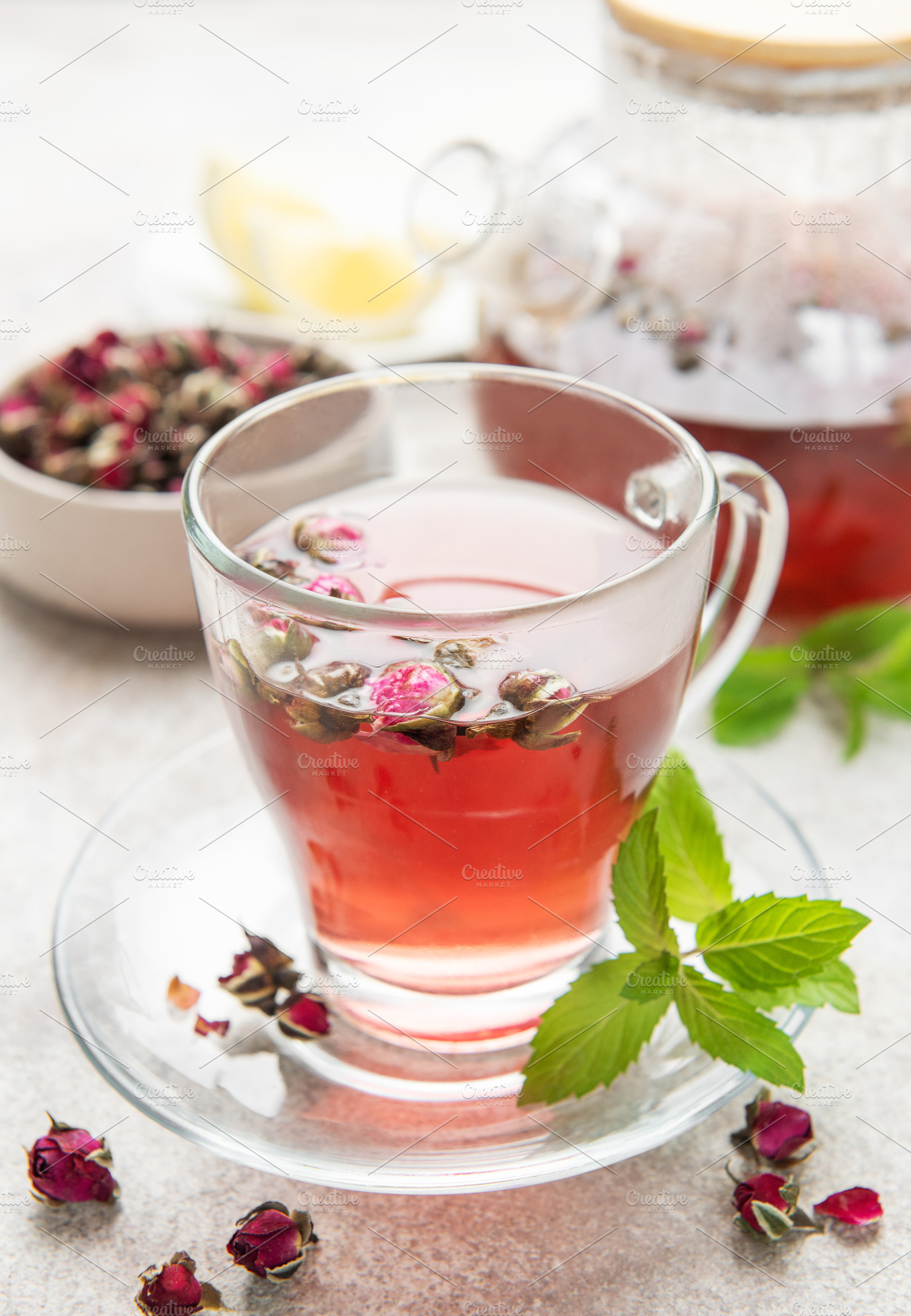 Rose bud tea infusion in glass mug on table, a Food & Drink Photo by Olena Rudo