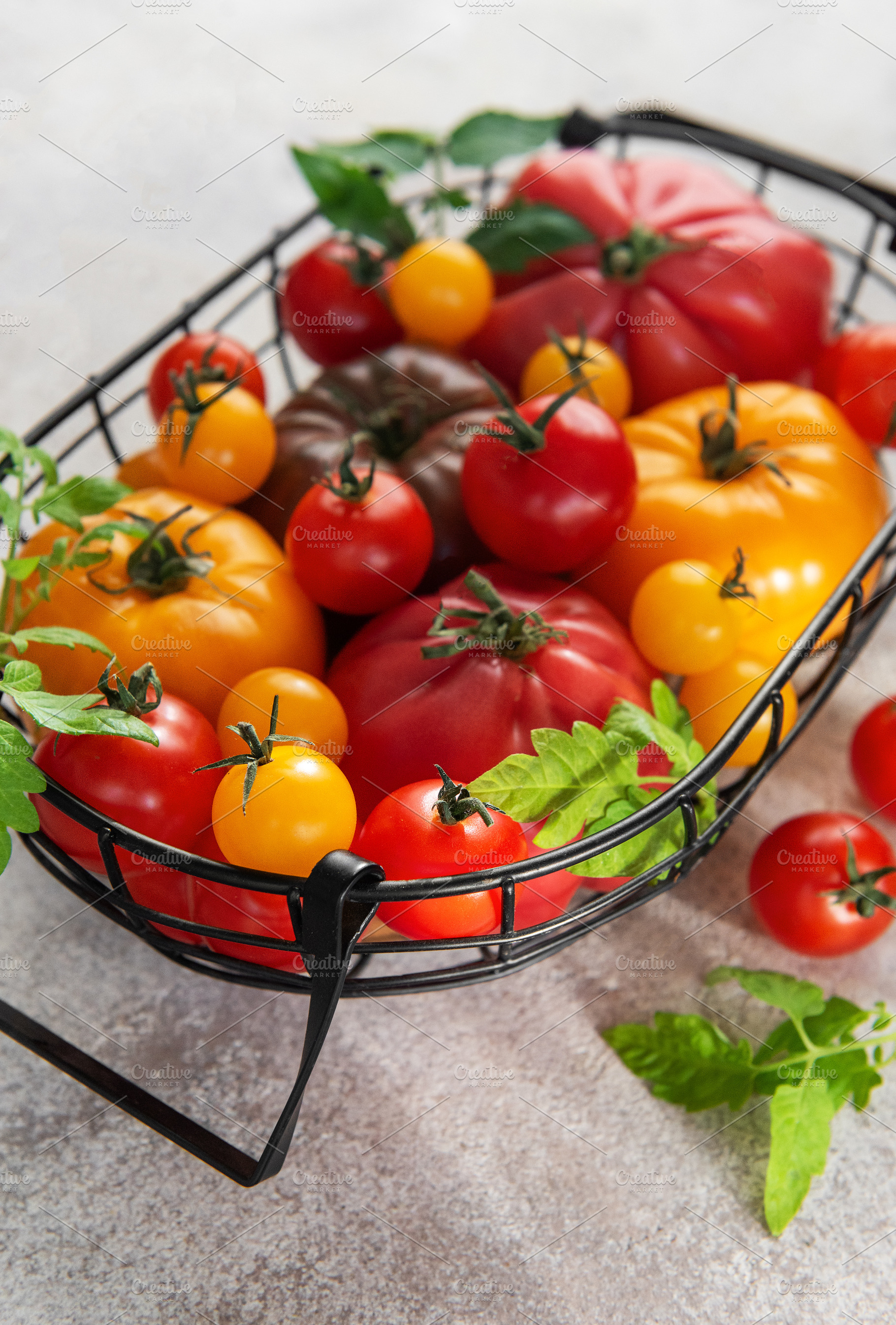 Fresh organic heirloom tomatoes in harvest basket from garden, a Food & Drink Photo by Olena Rudo