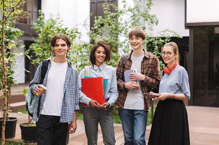 Young smiling students stock photo containing diploma and headphones