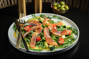 Salad with salted salmon and arugula, a Food & Drink Photo by Budarinphoto