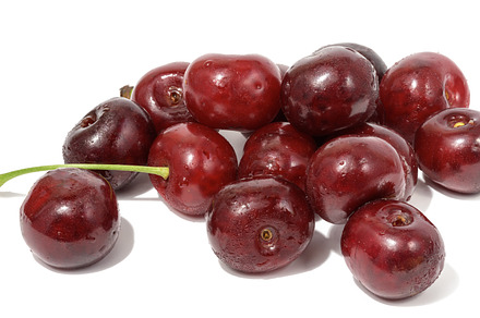 Ripe red cherry on a white isolated background, a Food & Drink Photo by ndanko