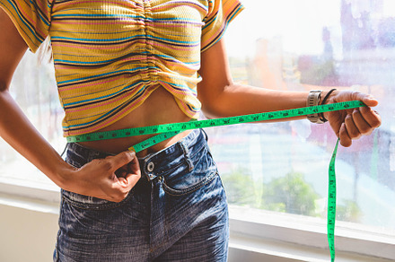Closeup of sport happy slim woman using waist tape line for meas, a Health & Medical Photo by Ministocker