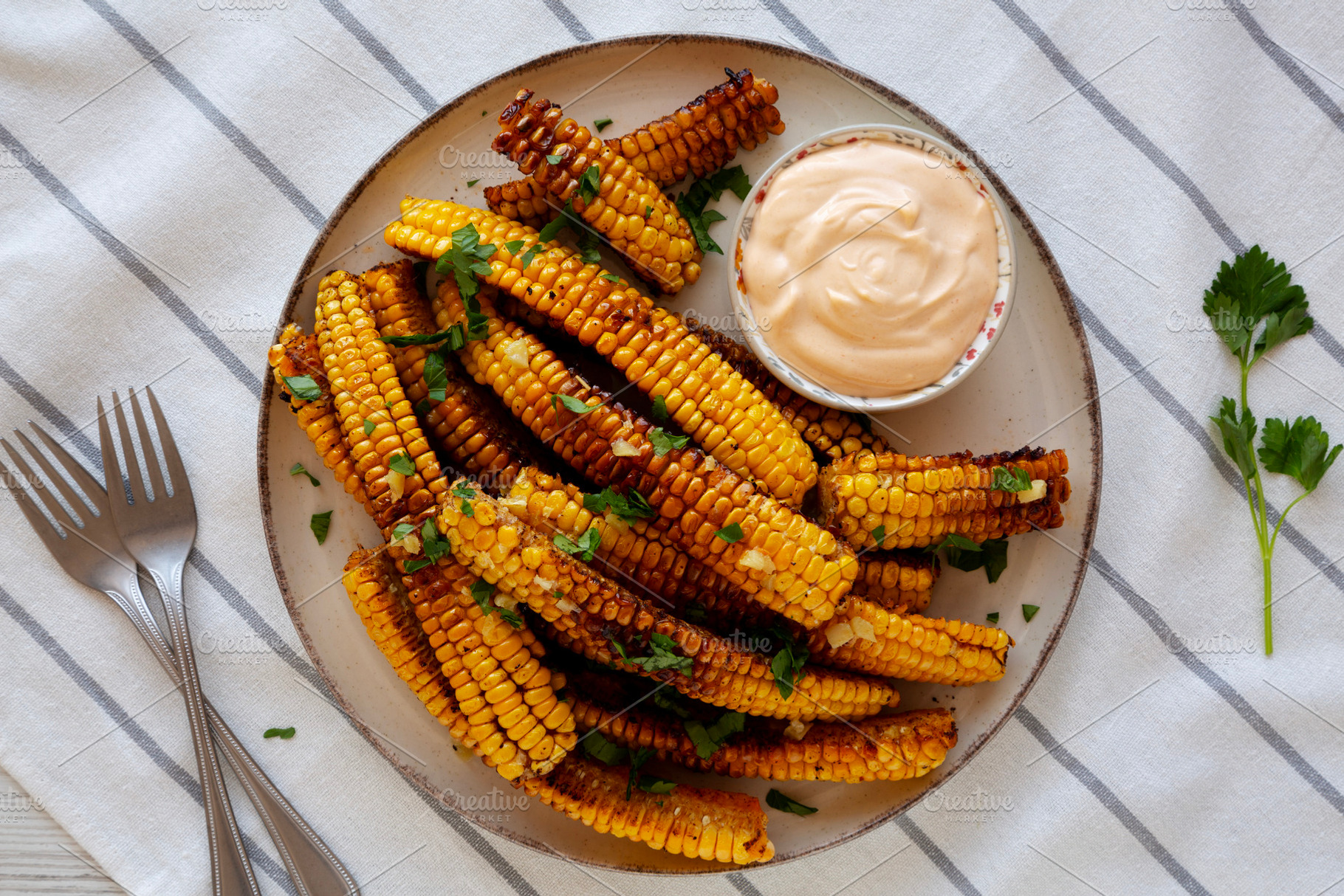 Homemade Spicy Corn Ribs with Mayo on a Plate, top view., a Food & Drink Photo by LiudmylaChuhunova