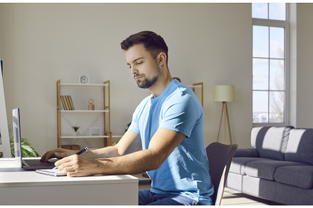 Young man studying from home, using, a School & Education Photo by StudioRomantic